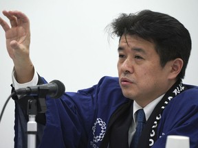 Hidemasa Nakamura, chief financial officer of the Tokyo 2020 Games, speaks on the updated version of the Games budget during a press conference in Tokyo Friday, Dec. 22, 2017. The latest price tag for the 2020 Tokyo Olympics has been trimmed slightly, but is still nearly twice the initial estimate even after a major cost-cutting effort. The organizers said Friday that the event will cost a total 1.35 trillion yen ($11.9 billion).