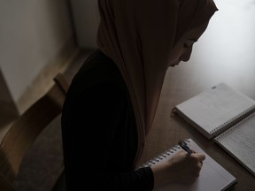 Iraqi teen Ferah, shown studying for an exam in Irbil, Iraq, in this Nov. 11, 2017 photo, says writing helped her endure during the rule of the Islamic State group over her home city of Mosul, giving her an outlet to explore her fears and hopes.