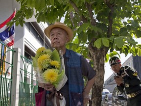 Sulak Sivaraksa pauses outside a military court Thursday, Dec. 7, 2017 in Bangkok, Thailand as he walks in to find out whether military prosecutor has proceeded with the indictment against him on lese majeste. A Thai military court has delayed a decision on whether to prosecute the prominent historian and social critic who suggested that a famed duel on elephant-back won by a Thai king against a Burmese prince 500 years ago may not actually have happened.