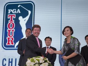 Greg Gilligan, PGA Tour's Greater China managing director, second from left, shakes hands with Hong Li, co-founder and Chairwomen of Shankai Sports, during a signing ceremony to announce their joint partnership and management of the PGA Tour China series for 20 years from 2018 at a hotel in Beijing Thursday, Dec. 7, 2017. Shankai, a Beijing-based firm, says its new venture is receiving a 300 million yuan ($45 million) investment from Yao Capital, a private equity firm co-founded by former Houston Rockets player Yao Ming, and U.S.-based IDG Capital.