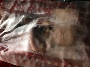 In this Aug. 7, 2017 photo, a Uighur child immigrant sleeps in a resettlement community in Kayseri in central Turkey. As Uighurs flee a Chinese security crackdown in droves, they often end up caught in a tug-of-war between militant Uighur members of Syria-based Islamic groups and moderate leaders of the Uighur diaspora who plead with them to reject calls of jihad.