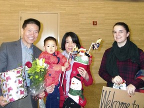 In this photo taken early morning of Dec 24, 2017 and released by China Aid, Li Aijie, center in red with her son Li Mutian poses for a photo with Bob Fu of China Aid at left and Kendra Willard, at right from the family hosting the mother and son upon their arrival at the Midland International Airport in Midland, Texas. Li who is seeking political asylum in the U.S. is the wife of Zhang Haitao. Zhang who was sentenced to 19 years in prison had been a rare voice in China, a member of the Han ethnic majority and salesman by day who complained on social media about government policies he said were unfair to Muslim minority Uighurs. (China Aid via AP)