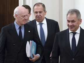 Russian Foreign Minister Sergey Lavrov, center, and Russian Defence Minister Sergei Shoigu, right, welcome UN Special Envoy for Syria Staffan de Mistura, left, prior to their talks in Moscow, Russia, Thursday, Dec. 21, 2017.