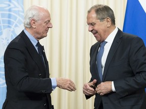 Russian Foreign Minister Sergey Lavrov, right, and UN Special Envoy for Syria Staffan de Mistura shake hands after a news conference following their talks in Moscow, Russia, Thursday, Dec. 21, 2017.