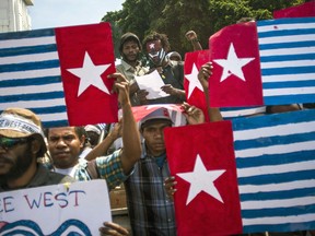 FILE - In this May 1, 2013, file photo, Papuans display "Morning Star" separatist flags during a protest commemorating the 50th year since Indonesia took over West Papua from Dutch colonial rule in 1963, in Yogyakarta, Indonesia. Prominent Papuans pleaded for the U.S. to give them money and arms in the mid-1960s to fight Indonesia's colonization of their vast remote territory, according to recently declassified American files that show the birth of an independence struggle that endures half a century later.