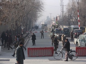 Afghan security personnel arrive at the site of suicide attack in Kabul, Afghanistan, Monday, Dec. 25, 2017.  A spokesman for the interior ministry says that the bomber blew himself up Monday near an office of the country's intelligence service.