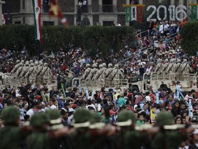 FILE - In this Sept. 16, 2016 file photo, people watch soldiers during the annual Independence Day military parade in Mexico City's main square, known as the Zocalo. Mexico's National Human Rights Commission denounced on Dec. 5, 2017 a case of alleged abuses in 2016 by members of the military, which is heavily involved in prosecuting the country's war against drug gangs.