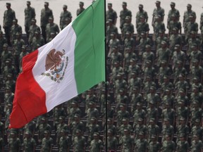 FILE - In this Sept. 13, 2016 photo, cadets attend a graduation ceremony at the Military Academy, in Mexico City. Mexico's Senate approved a law Friday, Dec. 15, 2017, that would give the military legal justification to act as police, despite objections from human rights groups.