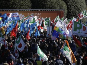 People gathers during a demonstration staged by the Democratic party, in Como, Italy, Saturday, Dec. 9, 2017.