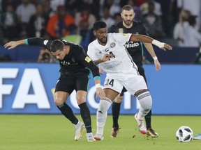 Real Madrid's Cristiano Ronaldo, left, challenge for the ball with Al Jazira's Eissa Mohamed during the Club World Cup semifinal soccer match between Real Madrid and Al Jazira Club at Zayed sport city in Abu Dhabi, United Arab Emirates, Wednesday, Dec. 13, 2017.