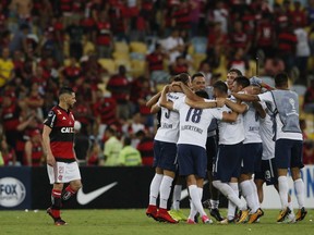 Argentina's Independiente players celebrate clenching the Copa Sudamericana championship title, after tying 1-1 with Brazil's Flamengo at Maracana stadium in Rio de Janeiro, Brazil, Wednesday, Dec.13, 2017. At left is Flamengo's Para.