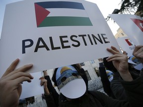 Protesters wearing masks with Jerusalem's Dome of the Rock Mosque, participate in a rally against U.S. President Donald Trump's decision to recognise Jerusalem at the capital of Israel, near the venue of Organisation of Islamic Cooperation's Extraordinary Summit in Istanbul, Wednesday, Dec. 13, 2017. Leaders and top officials from Islamic nations, members of 57-member Organization of Islamic Cooperation gathered for a summit that is expected to forge a unified stance against U.S. President Donald Trump's recognition of Jerusalem as the capital of Israel.