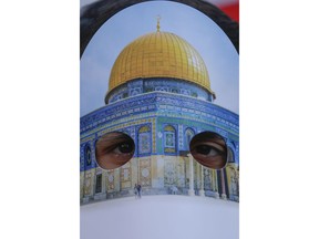 A protester wearing a mask with Jerusalem's Dome of the Rock Mosque, participate in a rally against U.S. President Donald Trump's decision to recognise Jerusalem at the capital of Israel, near the venue of Organisation of Islamic Cooperation's Extraordinary Summit in Istanbul, Wednesday, Dec. 13, 2017. Leaders and top officials from Islamic nations, members of 57-member Organization of Islamic Cooperation gathered for a summit that is expected to forge a unified stance against U.S. President Donald Trump's recognition of Jerusalem as the capital of Israel.