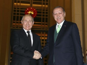 Turkey's President Recep Tayyip Erdogan, right, shakes hands with Russia's President Vladimir Putin, left, prior to their meeting at the Presidential Palace in Ankara, Monday, Dec. 11, 2017. Declaring a victory against "terrorists" in Syria, Putin earlier on Monday visited a Russian military air base in the country and announced a partial pullout of Russian forces from the Mideast nation.