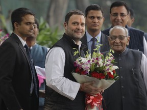 Senior Congress party leaders welcome their party vice president Rahul Gandhi , second left, with flowers as he arrives to file his nomination papers at party headquarters, in New Delhi, India, Monday, Dec. 4, 2017. Gandhi, the scion of India's Nehru-Gandhi political dynasty, has submitted nomination papers to succeed his mother as president of the main opposition Congress party that governed the country for decades.