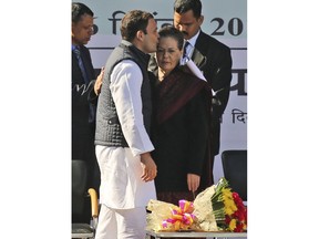 Newly-elected president of the main opposition Congress party Rahul Gandhi kisses his mother and former party president Sonia Gandhi during a function at the party headquarters in New Delhi, India, Saturday, Dec. 16, 2017. Rahul Gandhi, the scion of India's most famous political dynasty, has taken over as president of the main opposition Congress party while facing a stiff challenge from Prime Minister Narendra Modi and his ruling Hindu nationalists.