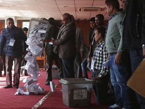 A Nepalese election commission officer empties a ballot box prior to counting the votes in Kathmandu, Nepal, Friday, Dec. 8, 2017. Election officials in Nepal on Friday began counting votes for national and provincial assemblies, the first time the Himalayan nation went to the polls to elect new federal units with the hope of bringing government closer to rural and remote areas.