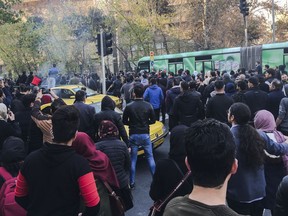 This photo taken by an individual not employed by the Associated Press and obtained by the AP outside Iran, demonstrators attend a protest over Iran's weak economy, in Tehran, Iran, Saturday, Dec. 30, 2017. A wave of spontaneous protests over Iran's weak economy swept into Tehran on Saturday, with college students and others chanting against the government just hours after hard-liners held their own rally in support of the Islamic Republic's clerical establishment. (AP Photo)