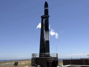 In this photo released by Rocket Lab, the Electron rocket, "Still Testing" is prepared for launch on the Mahia Peninsula, New Zealand, Tuesday, Dec. 12, 2017. The launch was scrubbed after an engine glitch on launch caused engineers to abort the flight. (Rocket Lab via AP)
