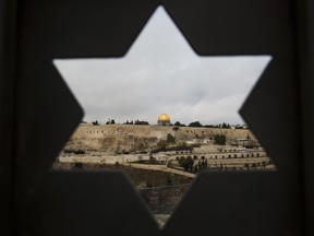 Jerusalem Old City is seen trough a door with the shape of star of David, in Jerusalem, Wednesday, Dec. 6, 2017. U.S. officials say President Donald Trump will recognize Jerusalem as Israel's capital Wednesday, Dec. 6, and instruct the State Department to begin the multi-year process of moving the American embassy from Tel Aviv to the holy city. His decision could have deep repercussions across the region.