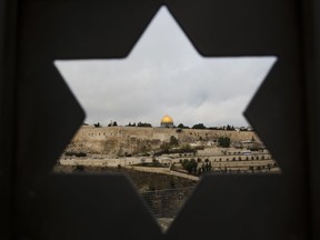 Jerusalem Old City is seen trough a door with the shape of star of David, in Jerusalem, Wednesday, Dec. 6, 2017.