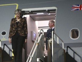 British Prime Minister Theresa May arrives at RAF Akrotiri, one of two military bases Britain maintains on the east Mediterranean island of Cyprus on Thursday, Dec. 21, 2017. May stopped off at RAF Akrotiri to wish servicemen and servicewomen happy holidays on her way back to the UK after a visit to Poland.