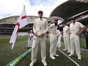 FILE - In this Dec. 3, 2017, file photo, England's captain Joe Root, center, prepares to lead his team onto the ground for the second day of their Ashes test match against Australia in Adelaide, Australia. Root's first Ashes tour as England cricket captain has been more eventful than he expected, just not in the way he had hoped.