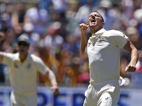 Australia's Josh Hazlewood celebrates the wicket of England's Chris Woakes, caught behind for 5 runs during the fifth day of their Ashes cricket test match in Adelaide, Wednesday, Dec. 6, 2017.
