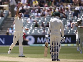 England's James Anderson, left, celebrates while believing he has taken the wicket of Australia's Peter Handscomb only to have it overturned by review during the fourth day of their Ashes cricket test match in Adelaide, Tuesday, Dec. 5, 2017.