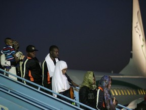 Nigerian returnees from Libya disembark from a plane upon arrival at the Murtala Muhammed International Airport in Lagos, Nigeria, Tuesday, Dec. 5, 2017. Hundreds of Nigerians arrived in Lagos on Tuesday, having been repatriated from Libya by the African Union (AU) amid outrage over recent footage that showed migrants being auctioned off as slaves.