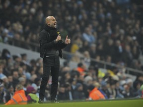 Manchester City manager Josep Guardiola reacts during the English Premier League soccer match between Manchester City and Tottenham Hotspur at Etihad stadium, in Manchester, England, Saturday, Dec. 16, 2017.