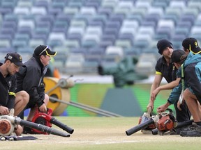 Ground staff dry the pitch with blowers before the start of the final day of the Ashes cricket test match between England and Australia in Perth, Australia, Monday, Dec. 18, 2017.