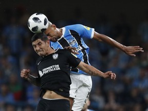 Brazil's Gremio Michel, right, and Mexico's Pachuca Victor Guzman jump for the ball during the Club World Cup semifinal soccer match between Gremio and Pachuca at the Hazza Bin Zayed stadium in Al Ain, United Arab Emirates, Tuesday, Dec. 12, 2017.