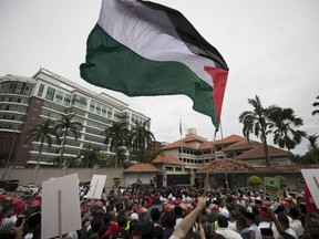 Protesters waves Palestine flags during a protest outside the U.S. Embassy in Kuala Lumpur, Malaysia, Friday, Dec. 8, 2017. Malaysian Muslims, including members of the ruling party, were protesting outside the U.S. Embassy over Washington's controversial move to recognize Jerusalem as Israel's capital.