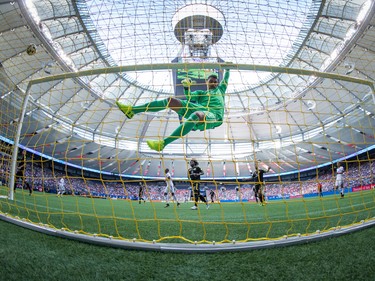 Columbus Crew keeper Zack Steffen hangs from the crossbar as a Vancouver Whitecaps shot sails by on Sept. 16.