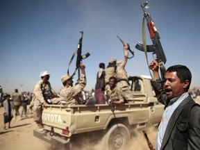 FILE - In this Jan. 3, 2017 file photo, tribesmen loyal to Houthi rebels chant slogans during a gathering aimed at mobilizing more fighters into battlefronts to fight pro-government forces, in Sanaa, Yemen. Yemenis in the war-torn country's capital crowded into basements overnight, Monday Dec. 4, 2017, as Saudi-led fighter jets pounded the positions of Houthi rebels, who are now fighting forces loyal to former Yemeni President Ali Abdullah Saleh for control of the city. A Sanaa-based protection and advocacy adviser for the Norwegian Refugee Council said Monday that the violence left aid workers trapped inside their homes and was "completely paralyzing humanitarian operations."