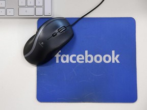 This file photo taken on December 4, 2017 shows a mousepad with the Facebook logo  at Facebook's  headquarters,in London.