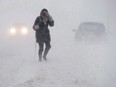 Pedestrian walks down Brunswick Street in Halifax as major storm blasts the Maritimes on Feb. 2017. A La Nina pattern forming in the Pacific Ocean is expected to bring wet weather to Canada's western coast this winter, while a polar vortex could be pushed from the North Pole to the Prairies.