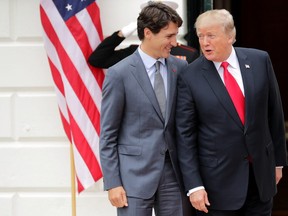 U.S. President Donald Trump and Canadian Prime Minister Justin Trudeau pose for photographs after Trudeau's arrival at the White House October 11, 2017