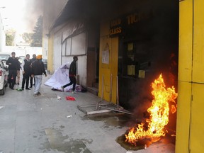 Smoke and fire emerges from a cinema ticket booth after an attack by activists in protest against the Bollywood film 'Padmaavat' in Jammu on January 24, 2018.