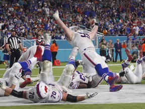 Buffalo Bills defensive tackle Kyle Williams (95) and a group of players celebrate after Williams scored a touchdown in the second half of Buffalo's victory over the Miami Dolphins on Sunday, Dec. 31, 2017.