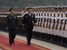 U.S. General Martin Dempsey (L) and his Chinese counterpart General Fang Fenghui inspect a guard of honour during a welcoming ceremony at the Bayi Building in Beijing on April 22, 2013.