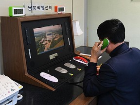 A South Korean government official checks the direct communications hotline to talk with the North Korean side at the border village of Panmunjom on January 3, 2018 in Panmunjom, South Korea.