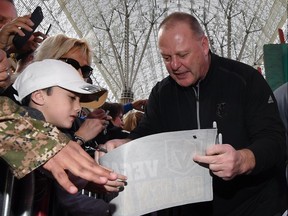 Gerard Gallant signs autographs for fans during the Vegas Golden Knights' fan fest at the Fremont Street Experience on Jan. 14, 2018.