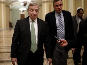 Sen. Dick Durbin (D-IL), accompanied by Sen. Mark Warner (D-VA) at right, speaks to reporters at the U.S. Capitol January 19, 2018 in Washington, DC.