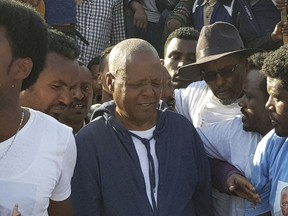 Opposition leader Merara Gudina, centre, walks with his supporters after his release, in Burayu, Ethiopia, Wednesday, Jan. 17 2018. Ethiopia's top opposition figure and hundreds of others were released from prison on Wednesday as part of the government's recent pledge to free detained politicians and "widen the democratic space for all" after the worst anti-government protests in a quarter-century. Gudina led the Oromo Federalist Congress party and was arrested a year ago under the country's state of emergency after he returned from Europe, where he had briefed European lawmakers on widespread and sometimes deadly anti-government protests.