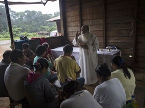 In this Jan. 15, 2018 photo, Father Pablo Zabala, better known as Padre Pablo, celebrates a private Mass for the Aguilar family in Boca Colorado, part of Peru's Madre de Dios province in the Amazon. The 70-year-old Spanish priest drove more than two miles and then walked another to reach the Aguilar family, who wished to give him a sendoff before his transfer to Puerto Maldonado.