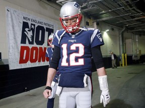 New England Patriots quarterback Tom Brady walks toward the field to warm up before the AFC championship NFL football game against the Jacksonville Jaguars, Sunday, Jan. 21, 2018, in Foxborough, Mass.