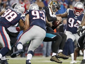Jacksonville Jaguars quarterback Blake Bortles (5) is sacked by New England Patriots defensive end Lawrence Guy (93) during the second half of the AFC championship NFL football game, Sunday, Jan. 21, 2018, in Foxborough, Mass.