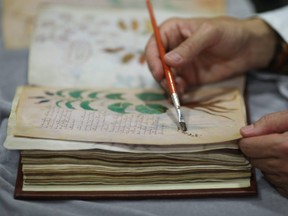 Quality control operator of the Spanish publishing outfit Siloe Luis Miguel works on cloning the illustrated codex hand-written manuscript Voynich in Burgos on August 9, 2016.